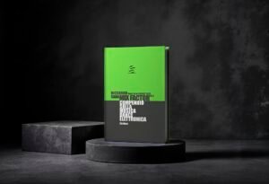 Green and black hardcover book on a circular pedestal in a dark studio setting, bold white typography on cover.