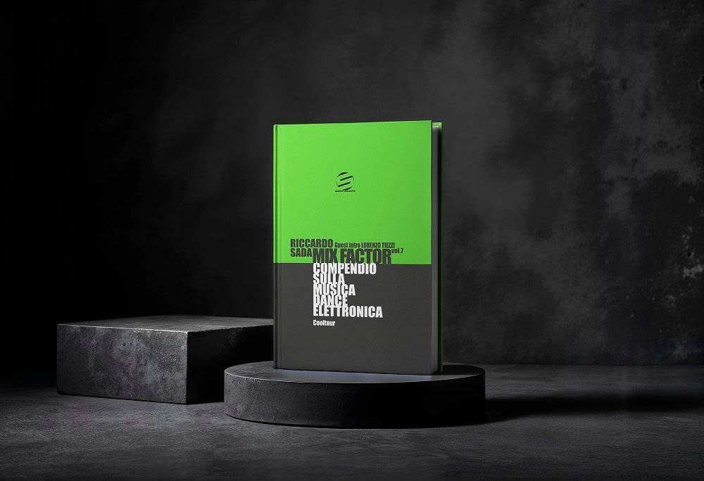 Green and black hardcover book on a circular pedestal in a dark studio setting, bold white typography on cover.